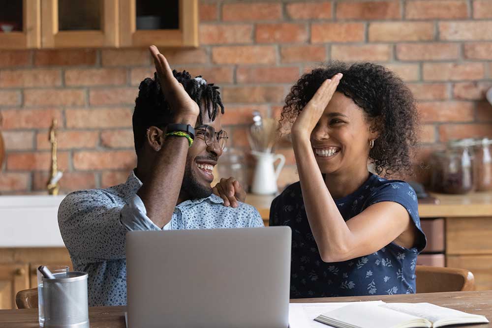 Relieved couple celebrating after resolving debt issues, symbolizing legal help against unfair debt collection practices.