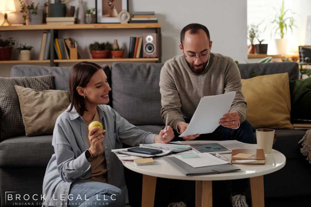 Couple reviewing documents together, reflecting on their eligibility for Chapter 13 bankruptcy repayment plans in Indiana.