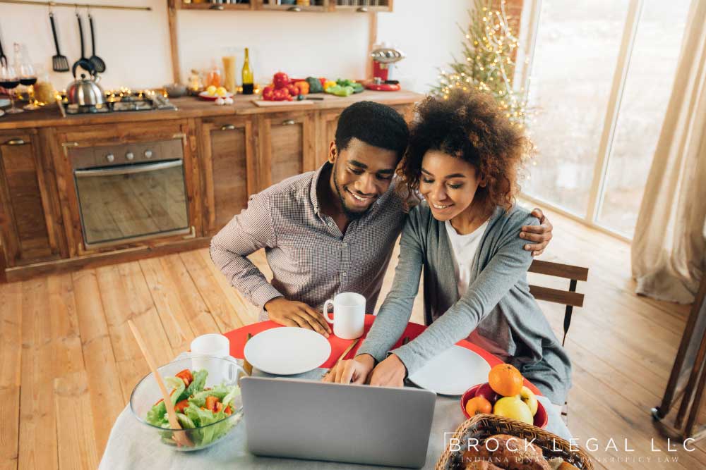 Couple enjoying breakfast together, researching bankruptcy options with Brock Legal in the comfort of their home.