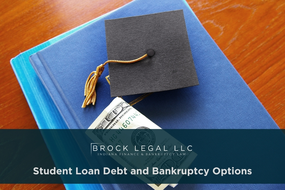 A graduation cap rests on a blue book with a hundred-dollar bill partially visible, symbolizing student debt. Brock Legal, an Indiana bankruptcy law firm, offers financial recovery and legal consultation for those seeking debt relief solutions.| Brock Legal, LLC